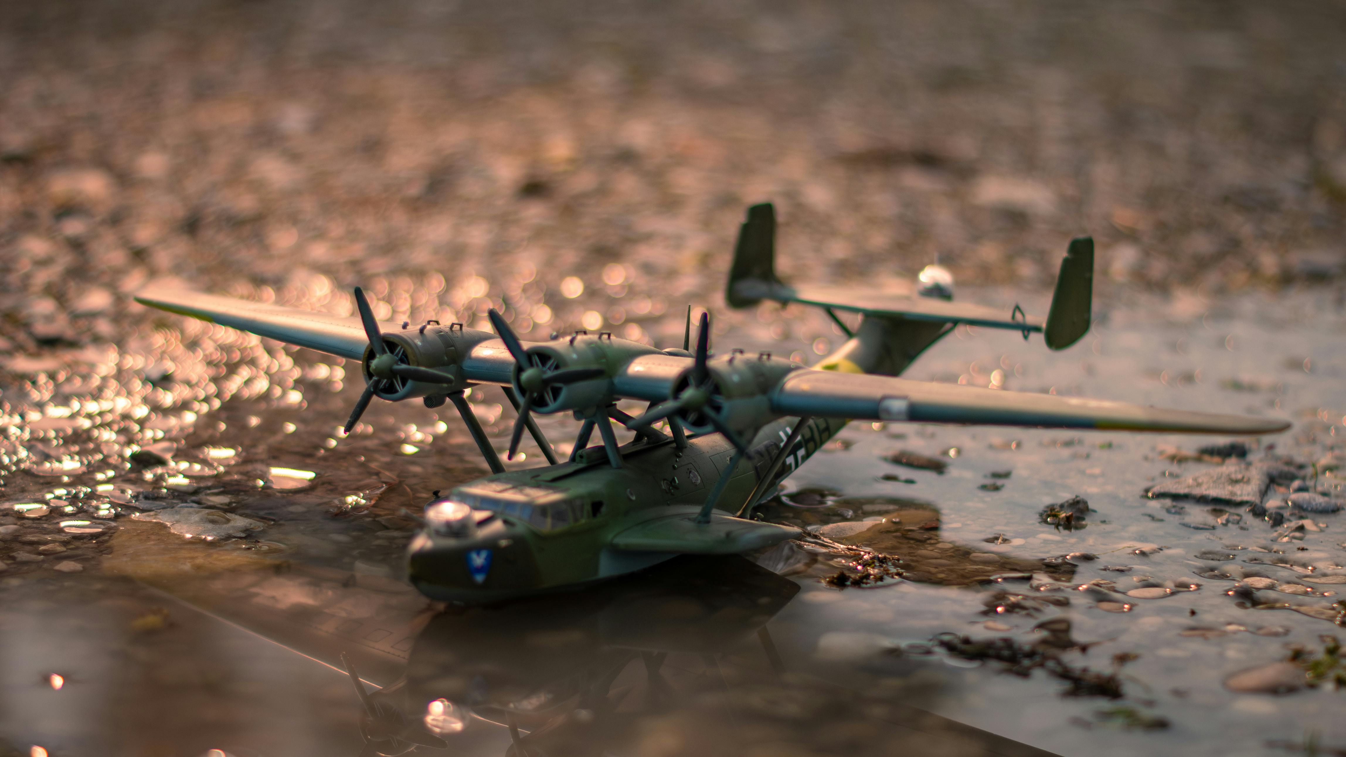 toy army airplane in mud