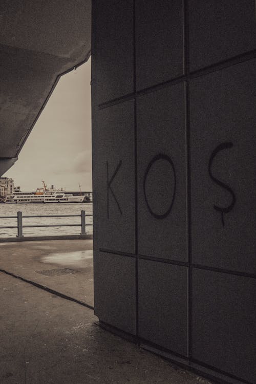 A Text Written with Spray on a Wall of a Building by the Port in City 