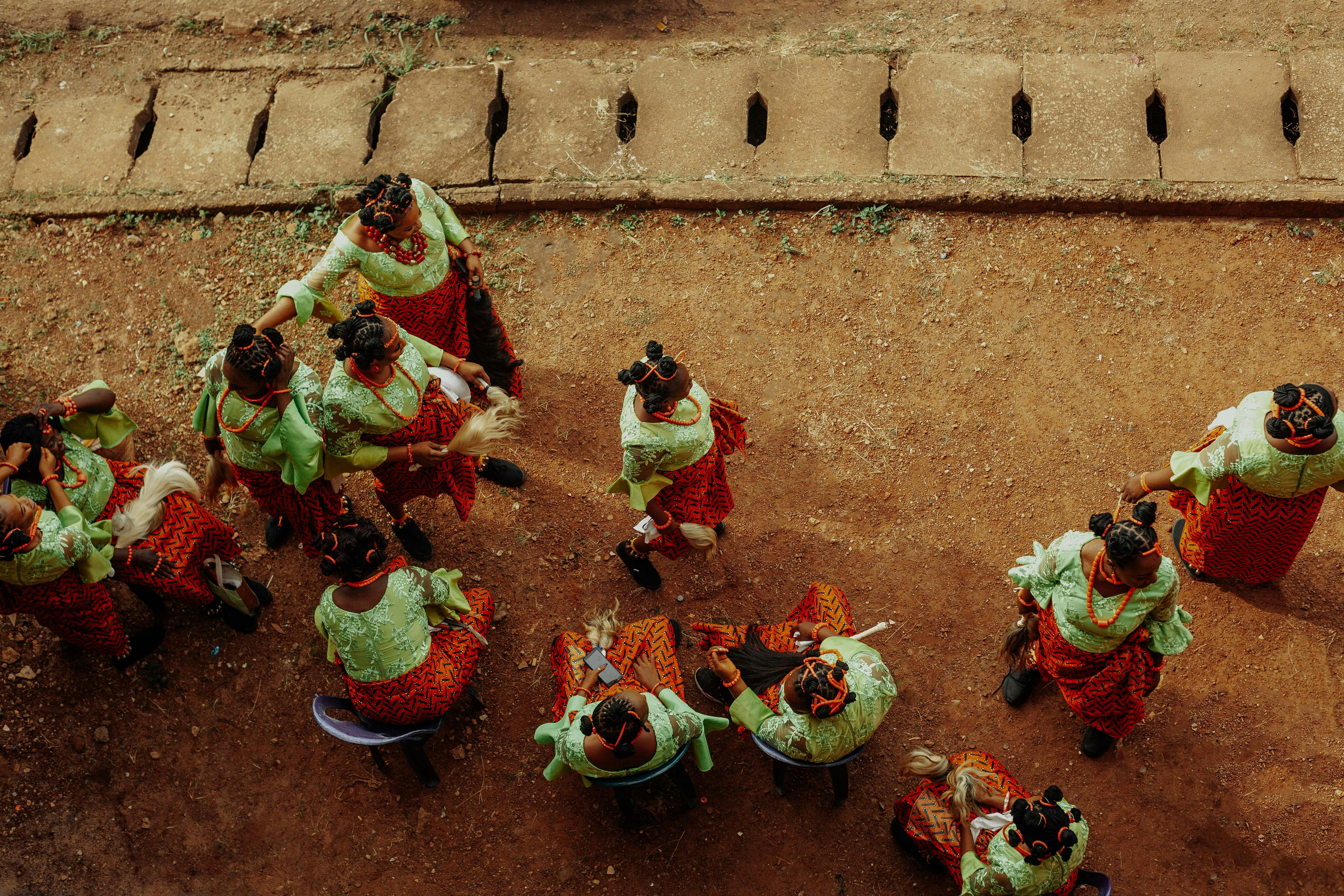 Group of women in vibrant traditional clothing seen from above, showcasing cultural heritage.