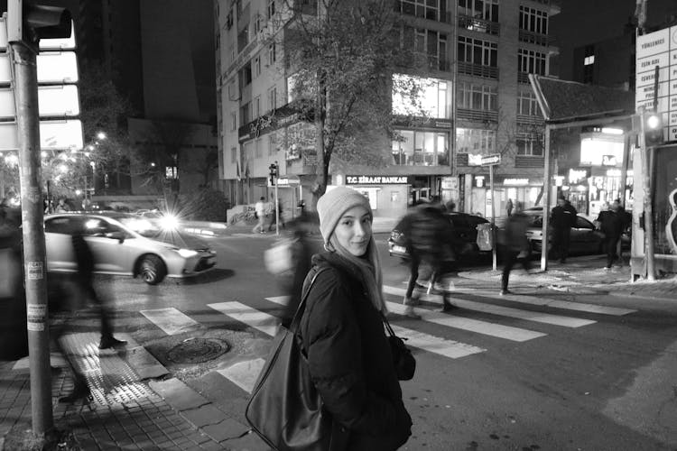 Woman In Hat And Puffer Jacket In City