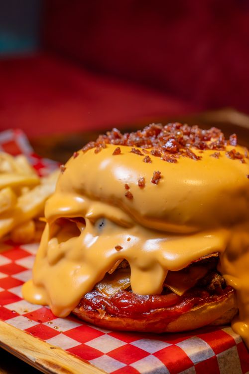 Free Mouthwatering cheeseburger oozing with melted cheese and crispy bacon. Stock Photo