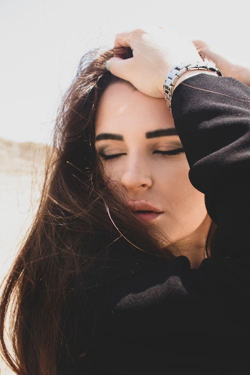 Young Woman With Closed Eyes and Holding Her Hair · Free Stock Photo