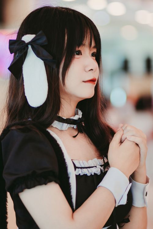 Free Young adult cosplayer in anime-inspired costume posing indoors. Stock Photo