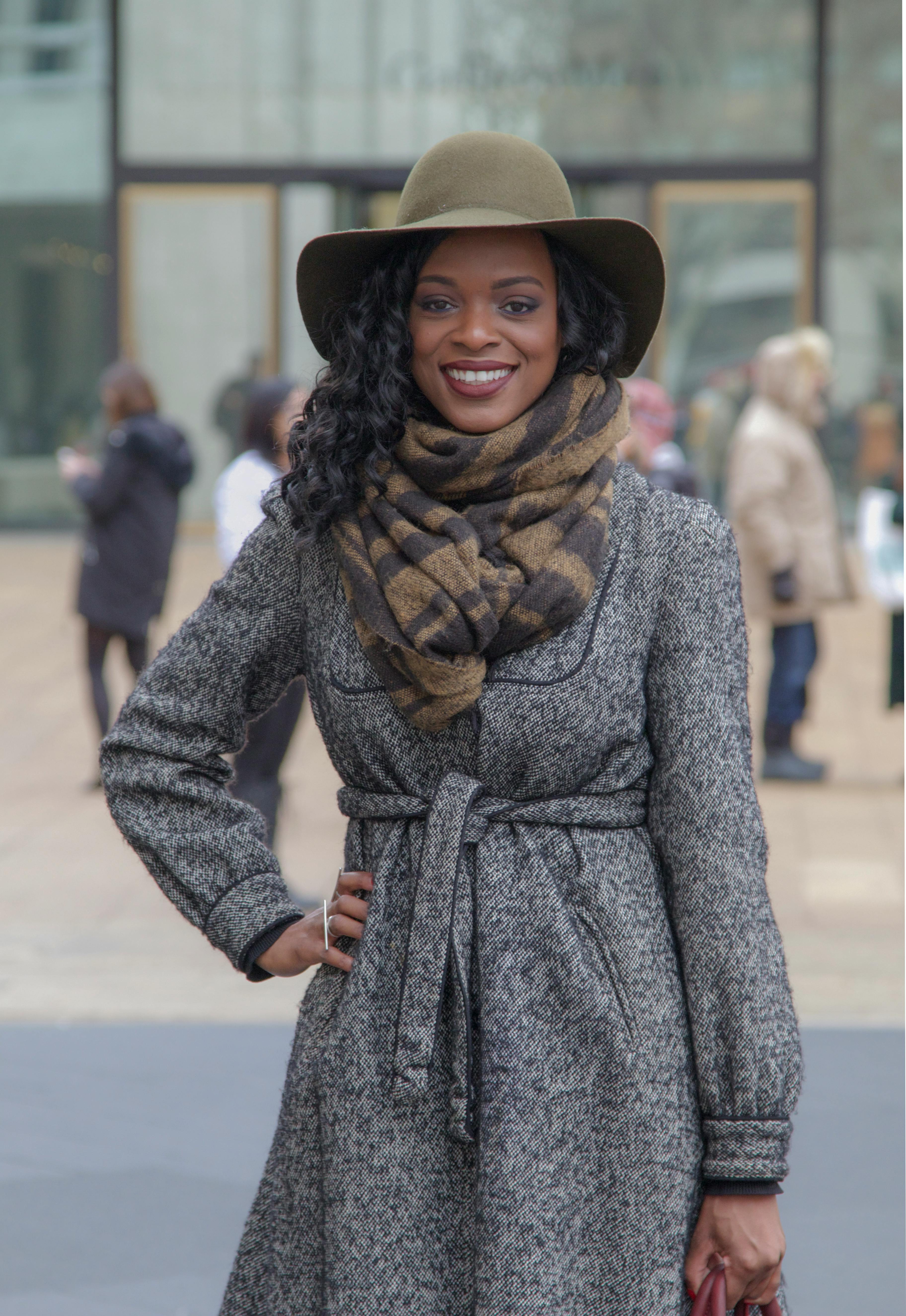 Chic woman in winter fashion posing outdoors in New York City.