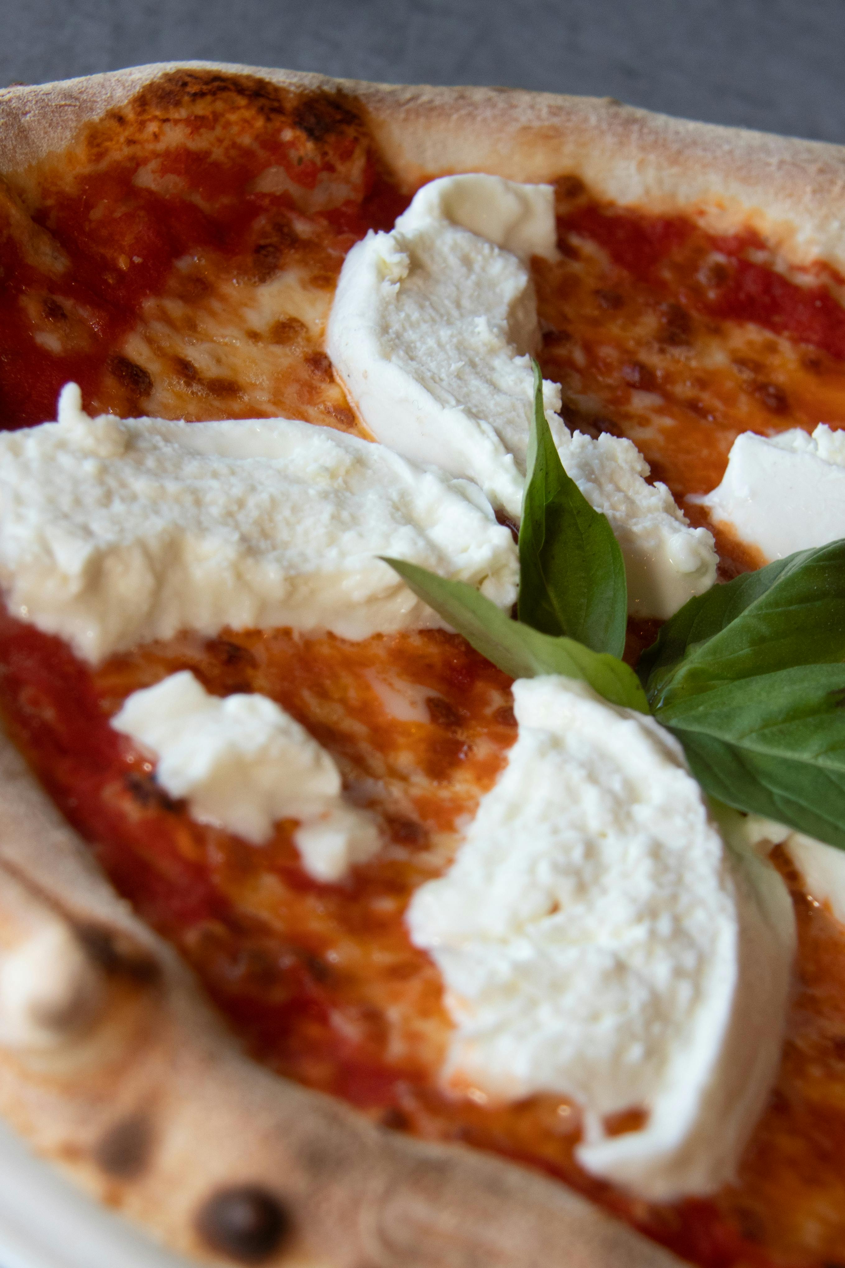 Close-up of a freshly baked Margherita pizza with mozzarella and basil.