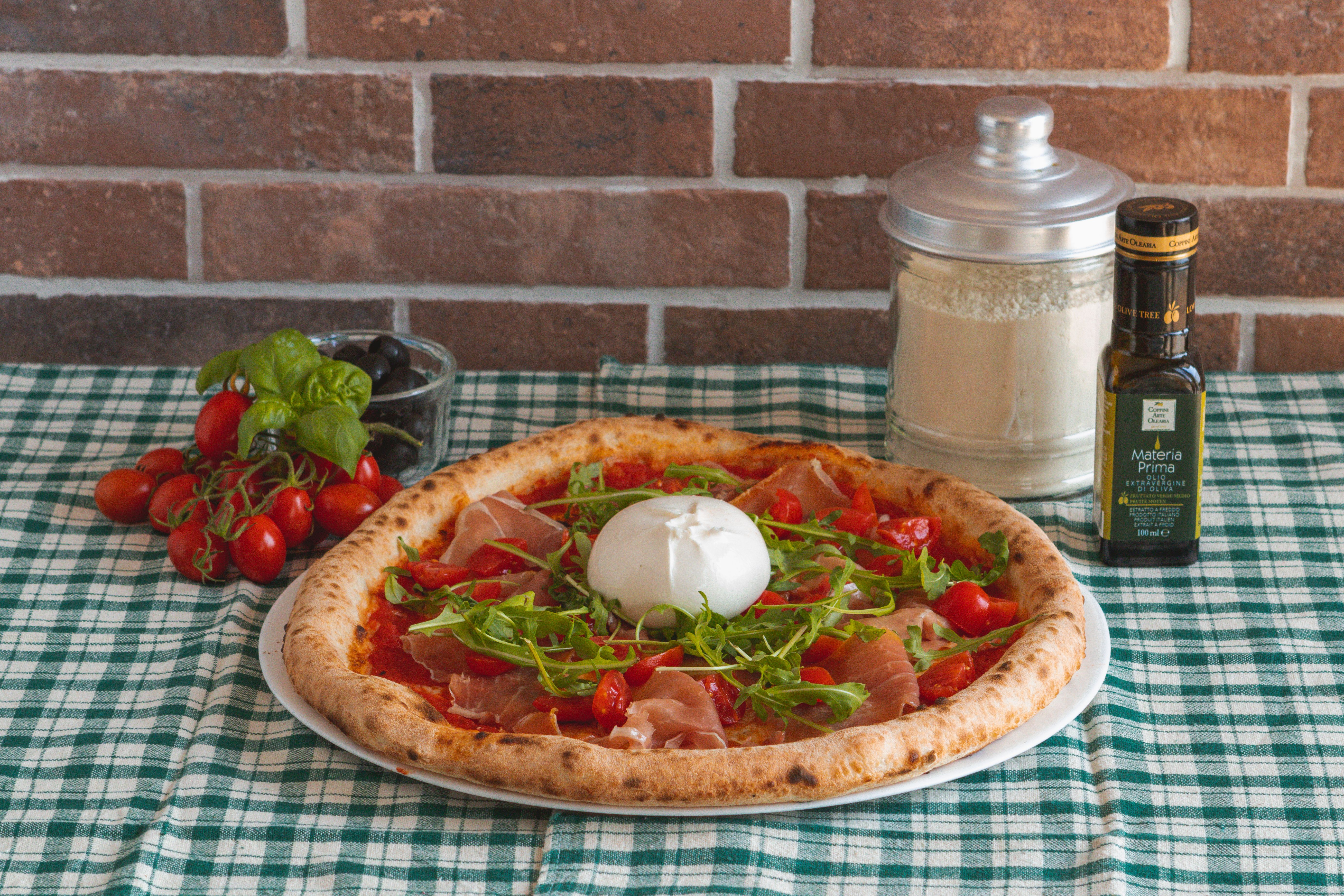 Close-up of prosciutto and burrata grilled pizza sandwich with arugula leaves