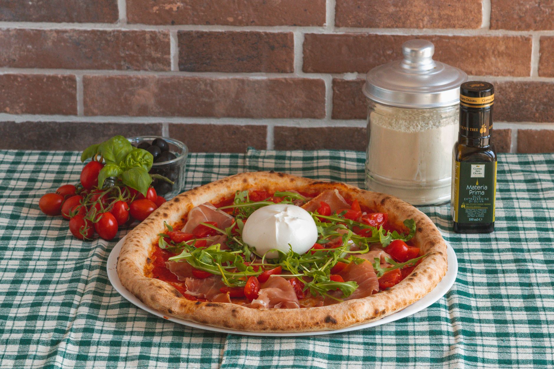 Close-up of prosciutto and burrata grilled pizza sandwich with arugula leaves