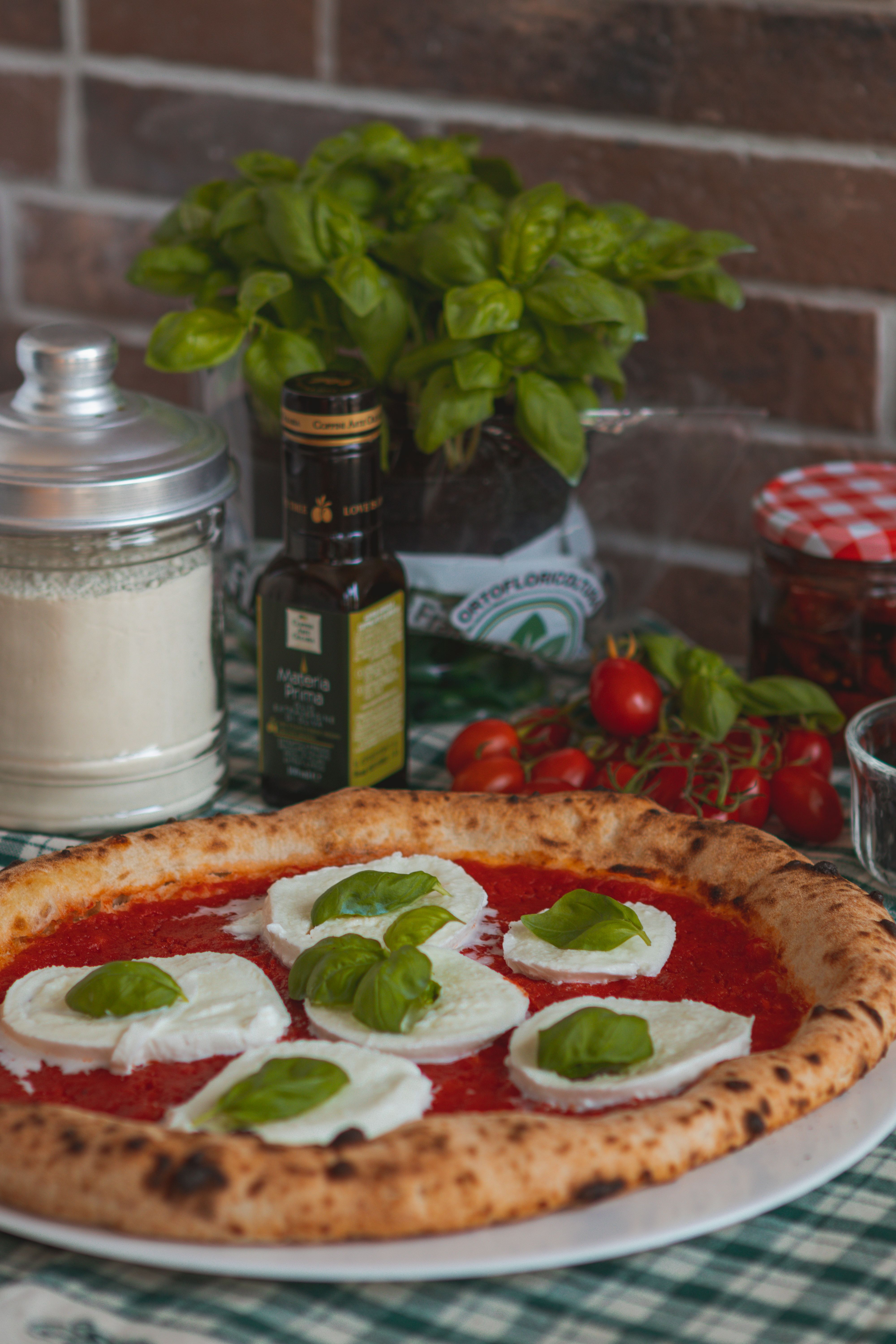 Delicious homemade Neapolitan pizza with fresh basil and cheese on a rustic table.