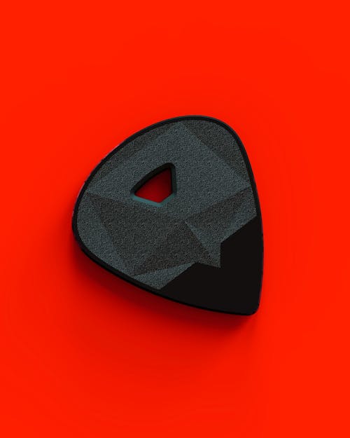 Guitar Pick on Red Background