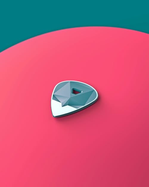 Guitar Pick on Pink Background