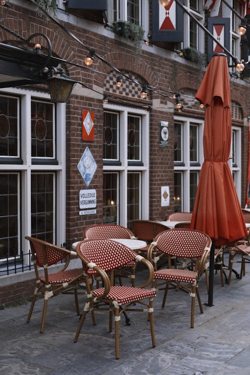 Cafe Chairs near Vintage Building Wall