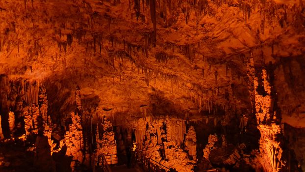 Explore the mesmerizing stalactites and stalagmites in this illuminated Turkish cave.