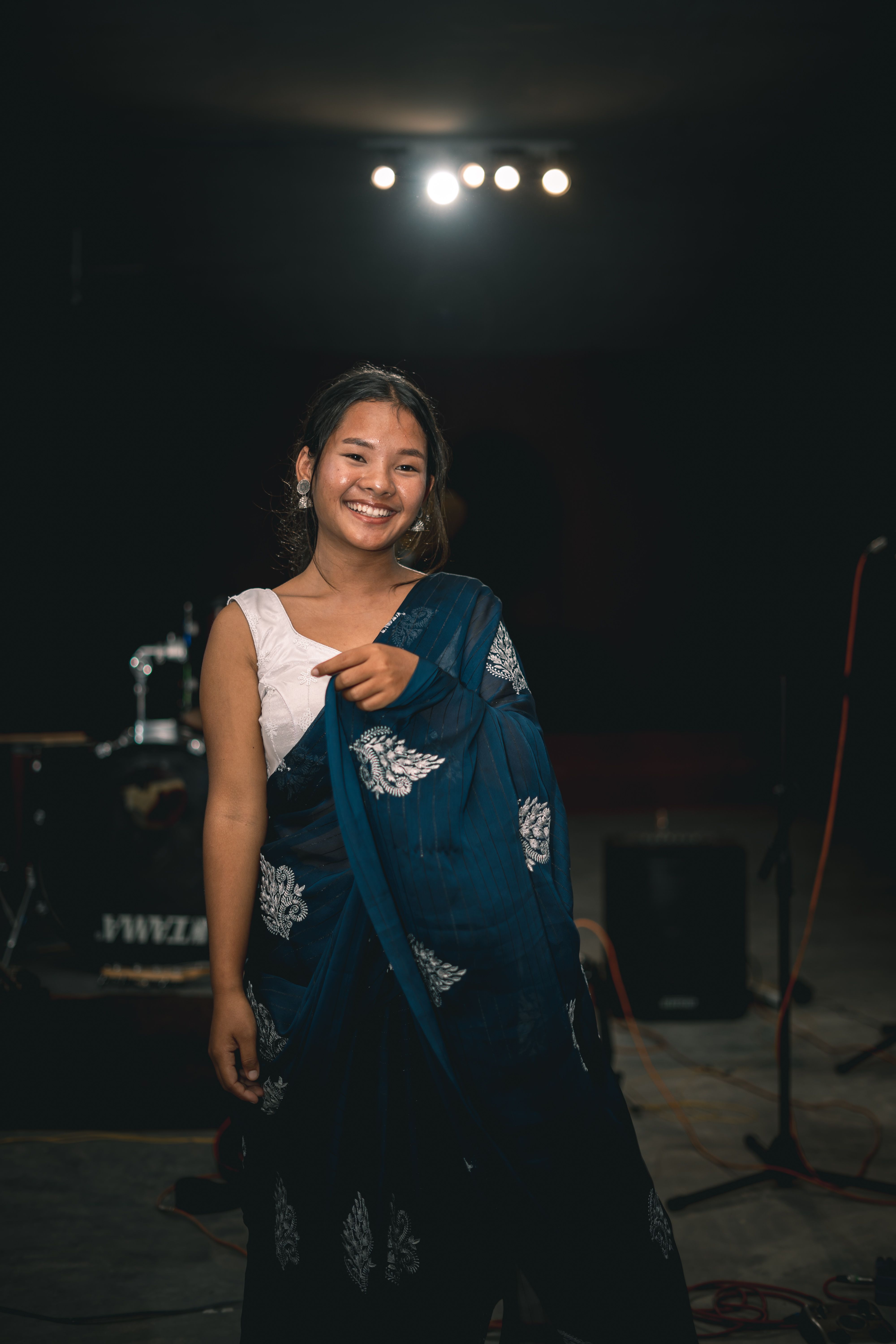 Young Woman in a Gown Standing in a Room with Musical Instruments ...