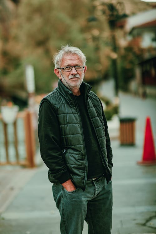 Elderly Man Standing with his Hands in Pockets 