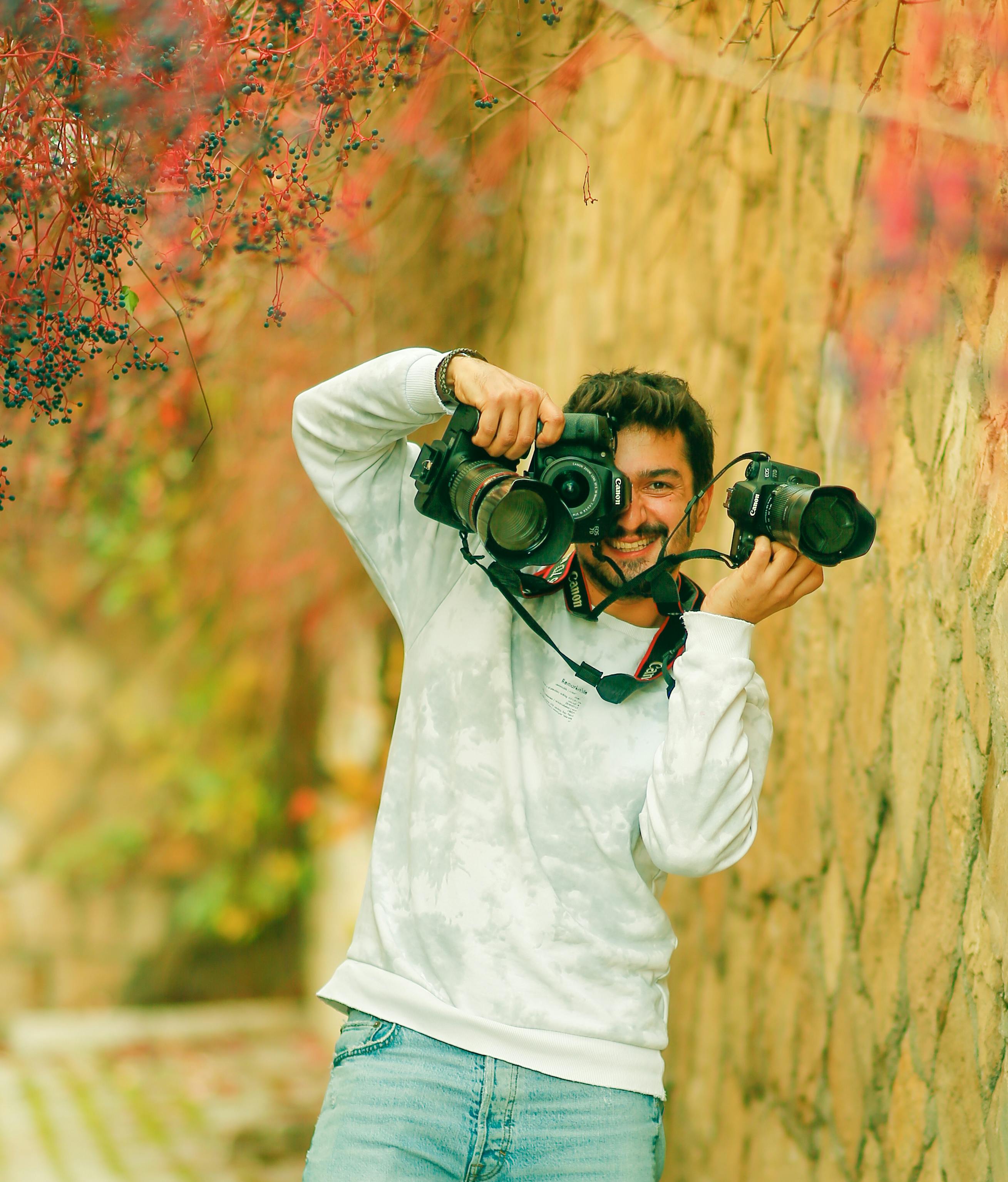 Stylish indian young man photographer wear casual posed outdoor with dslr  photo camera at hands. 10500015 Stock Photo at Vecteezy
