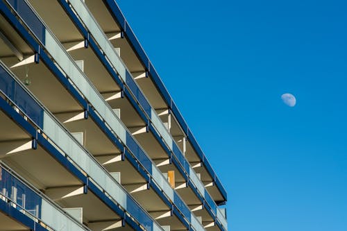 Moon in Daylight over a Modern Hotel