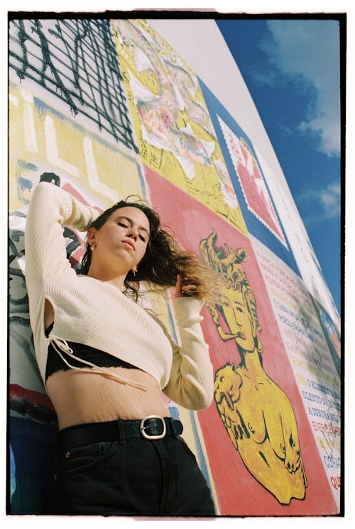 Woman Posing in White Top and Black Pants