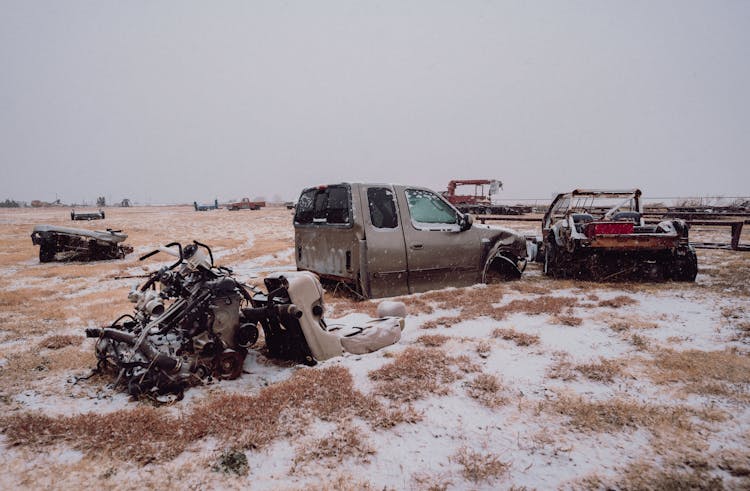 A Truck Is Parked In The Snow With A Wrecked Car