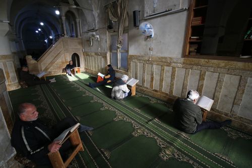 Free A group of men reading the Koran inside a historic mosque in Idlib, Syria. Stock Photo