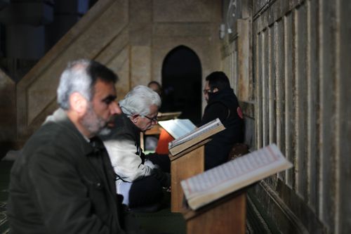 Free Senior men reading in a mosque in Idlib, Syria, highlighting traditional Islamic practices. Stock Photo