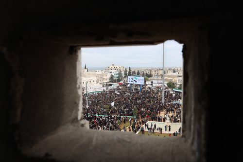 Free Crowd gathers at a public event in Idlib, Syria, viewed through an aperture. Stock Photo