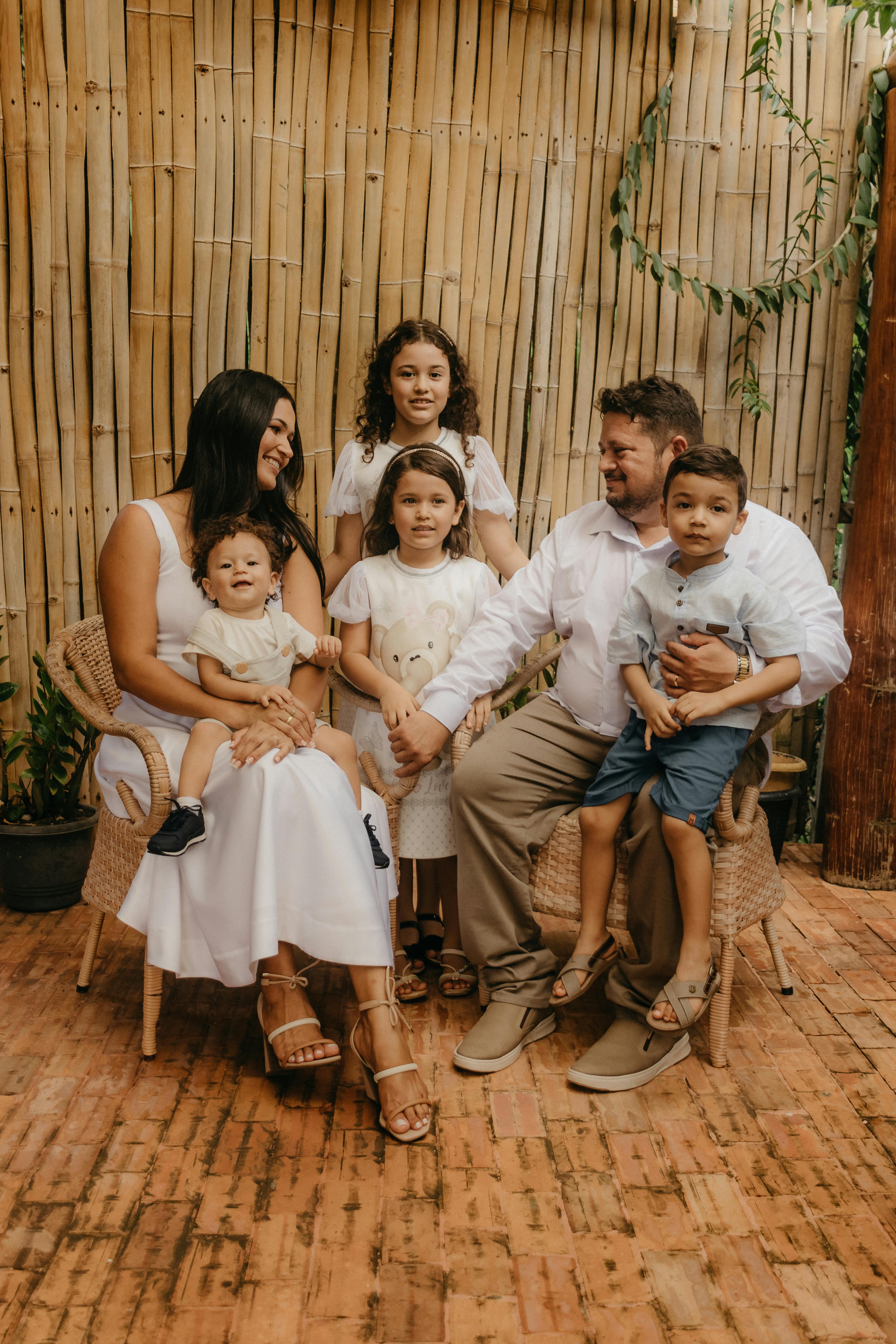 family with four kids posing on a terrace