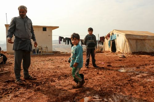 Free A rural Syrian family with children near a tent, depicting life in Idlib. Stock Photo