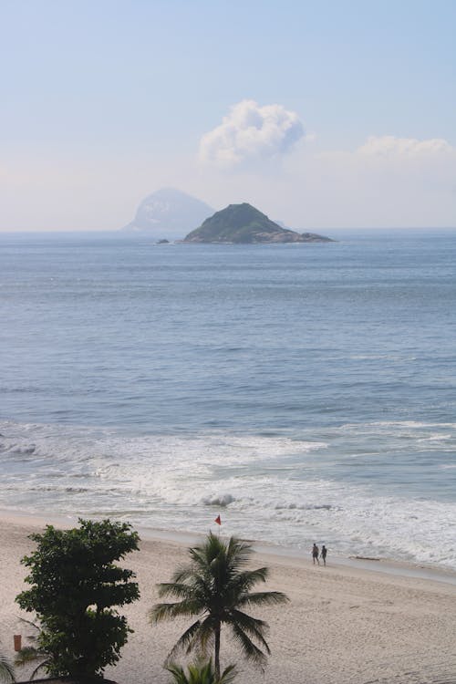 View of a Tropical Shore and an Island in the Horizon
