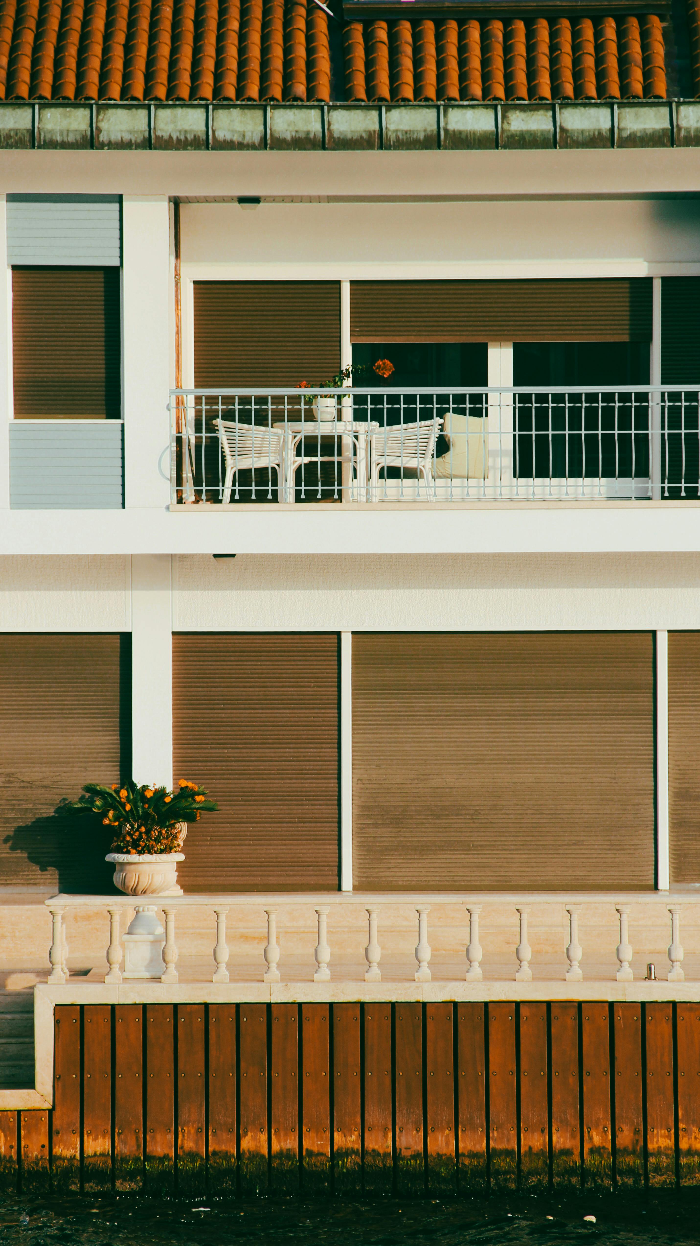 a balcony with a table and chairs on it