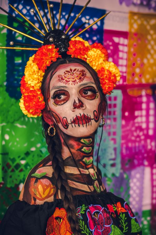 Free Colorful portrait of a woman with calavera makeup celebrating Dia de los Muertos. Stock Photo