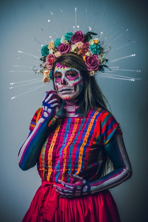 A woman dressed in a skeleton costume with flowers · Free Stock Photo