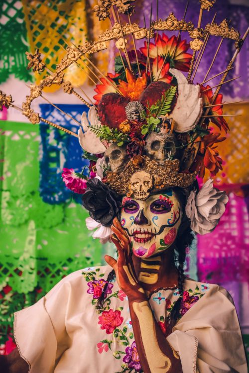 Free Colorful portrait of a woman in Catrina makeup celebrating Dia de Muertos. Stock Photo