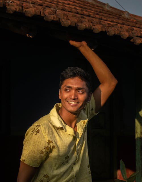 Smiling Man in Shirt and with Arm Raised