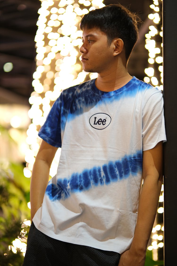 Model In A White Lee T-shirt With A Printed Logo And Blue Pattern