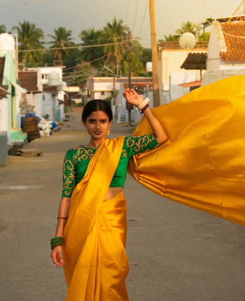 Indian woman flaunting her beautiful yellow saree 