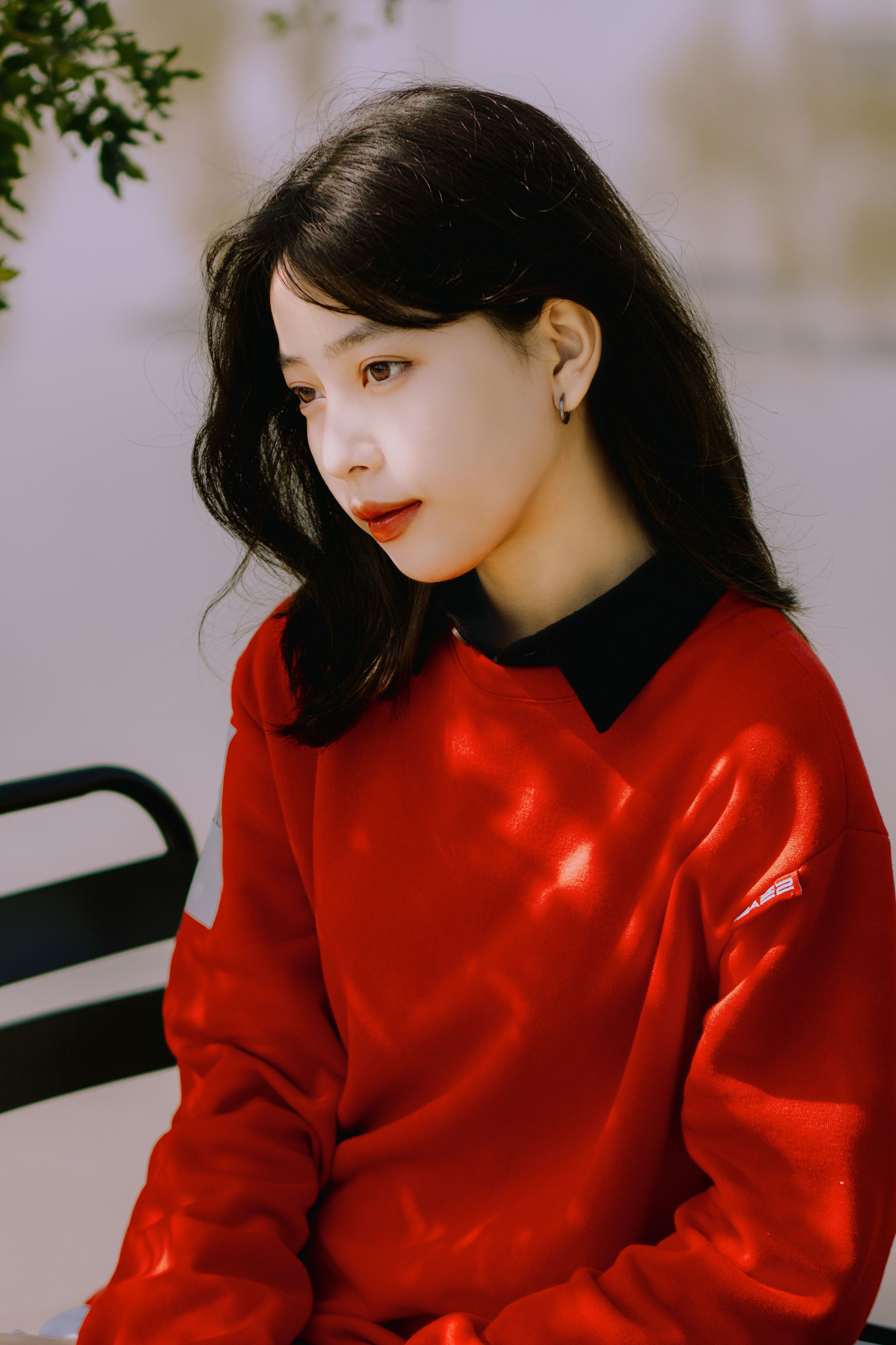 Woman Wearing Red Sweater Sitting on a Chair · Free Stock Photo