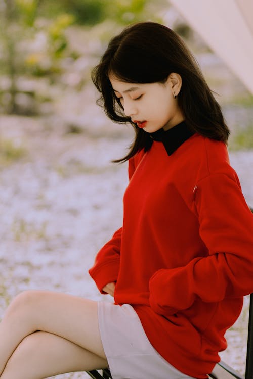 Free Woman Sitting in Red Clothes Stock Photo