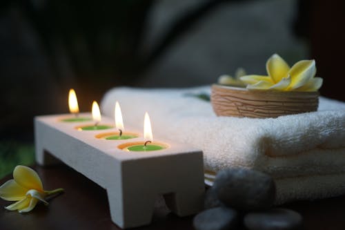 Lighted Candles on White Candle Holder