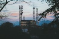 Telecommunication towers in a mountainous landscape at sunset in Campo dei Fiori, Italy.