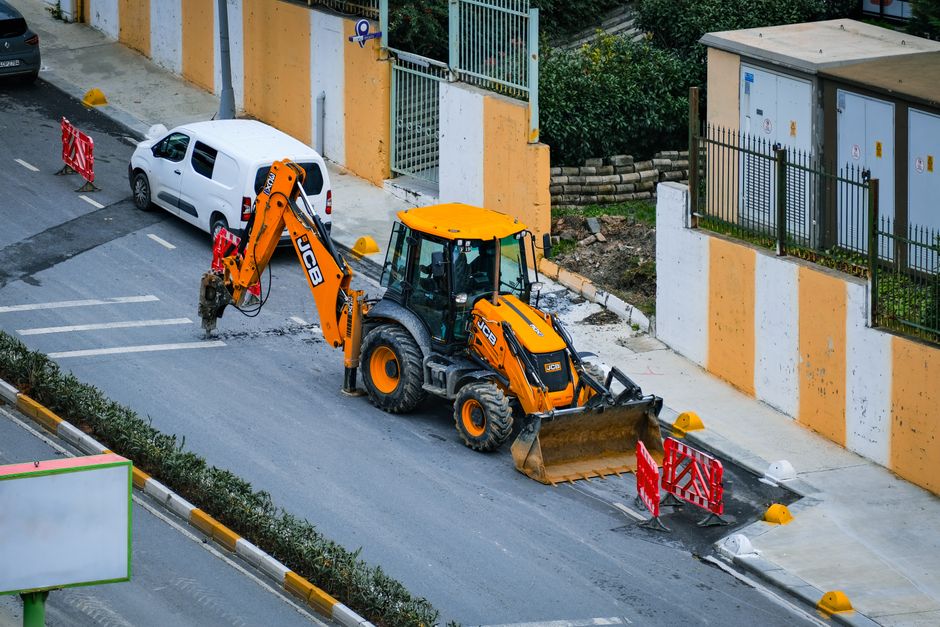 A street in Istanbul featuring an excavator active in road construction work.