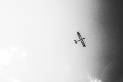 Free Monochrome photo of an airplane flying high against a clear sky, capturing minimalism and freedom. Stock Photo