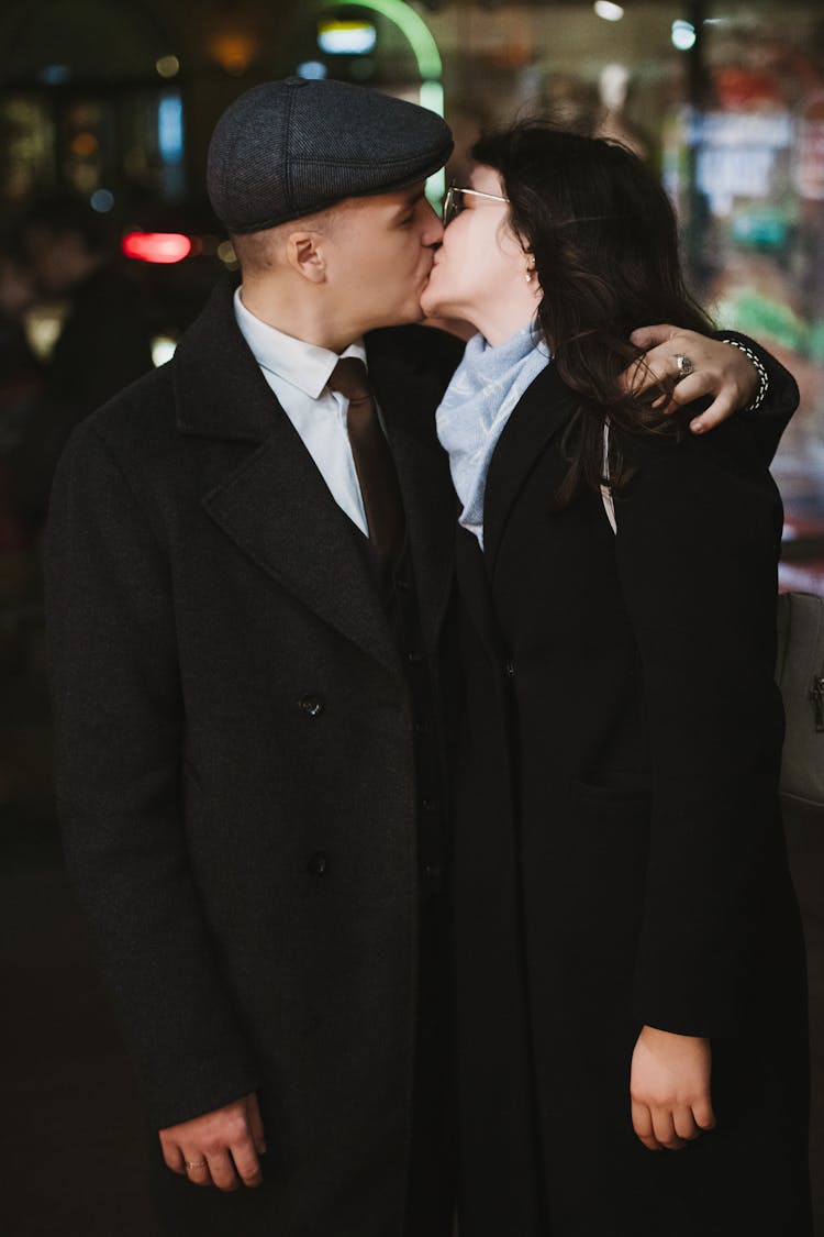 Couple Dressed In Black Suits Kissing