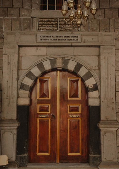 Free Elegant wooden arch doorway with intricate details in a historic setting. Stock Photo