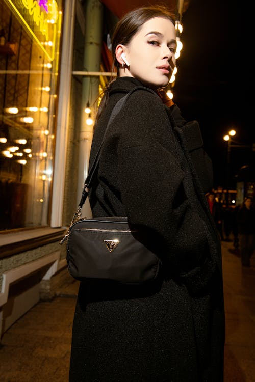 Brunette with Purse in City at Night
