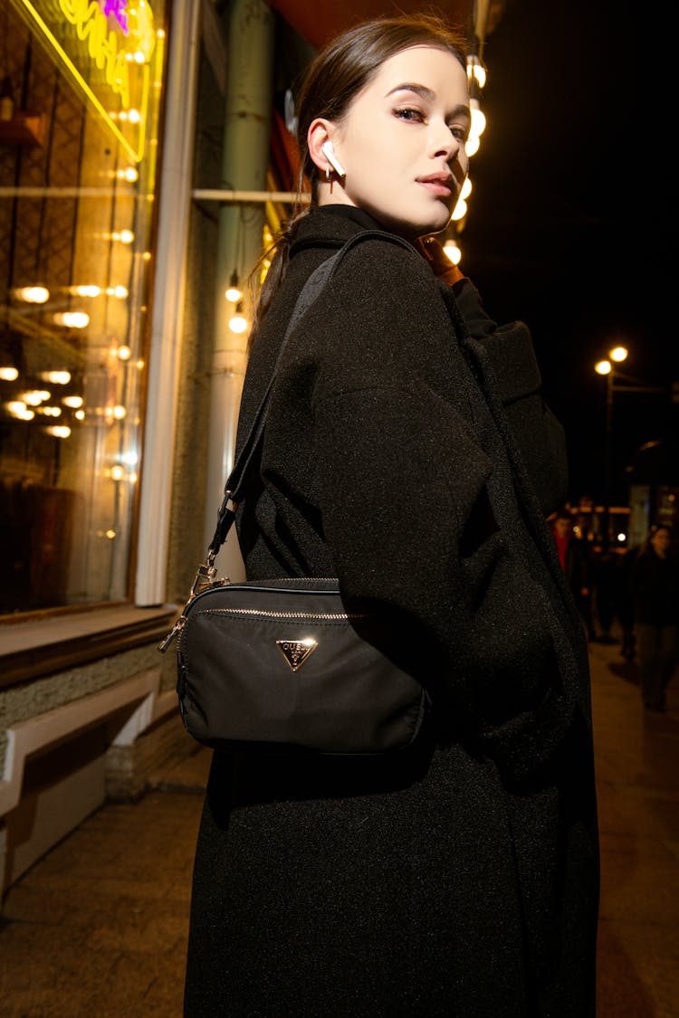 Brunette With Purse In City At Night