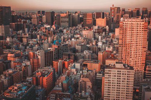 Free A stunning aerial view of Tokyo's urban landscape at sunset, showcasing skyscrapers and bustling streets. Stock Photo