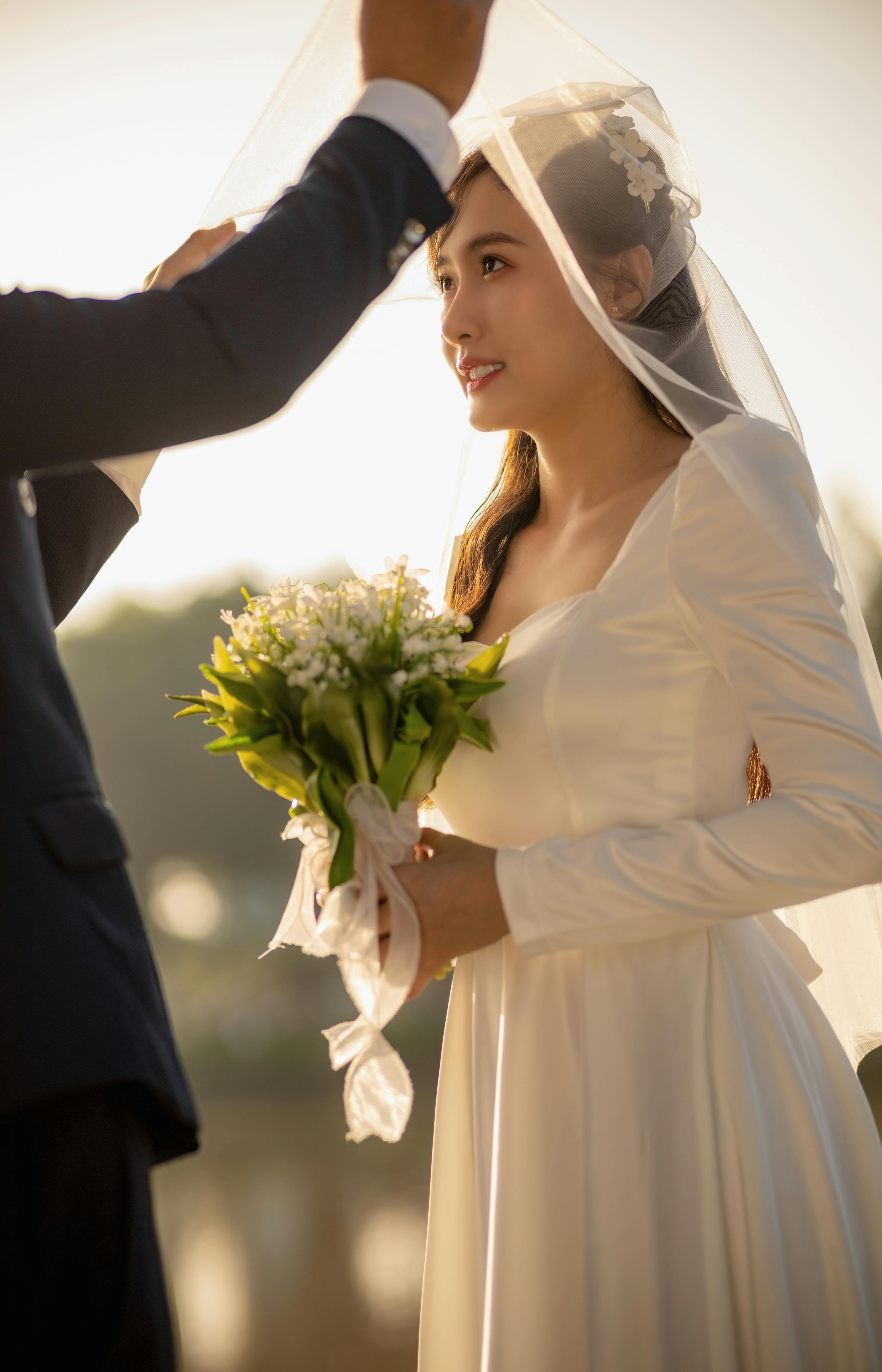 bride in wedding dress and with flowers