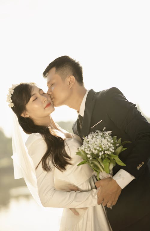 Portrait of Newlyweds Kissing with Eyes Closed