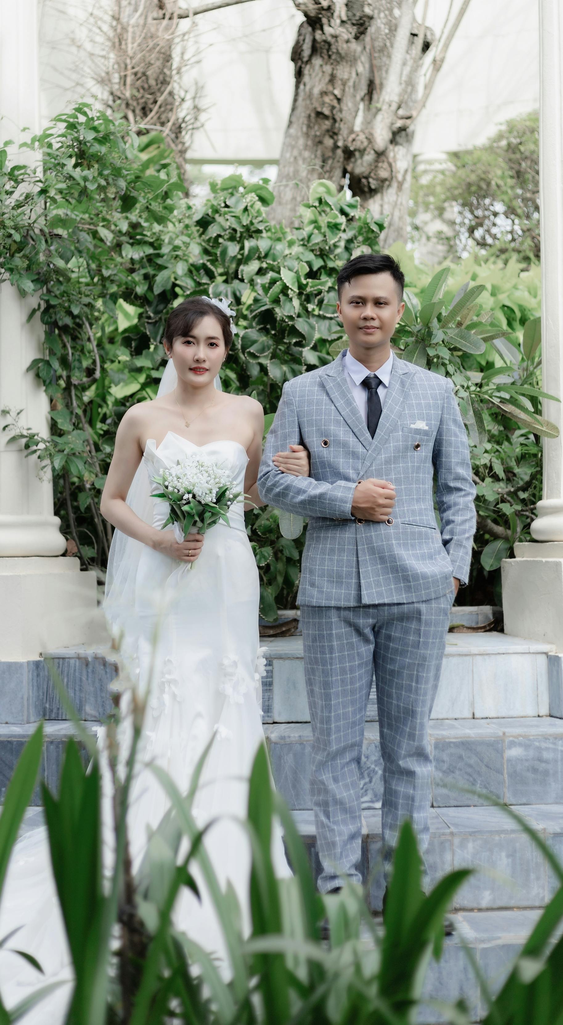 Beautiful portrait of a bride and groom in a lush garden setting.