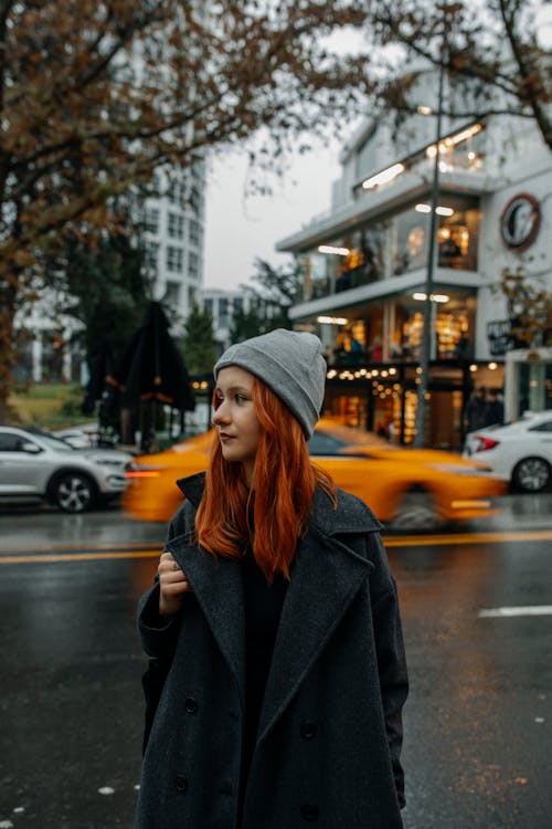 Young Woman in Gray Beanie and Coat on Street